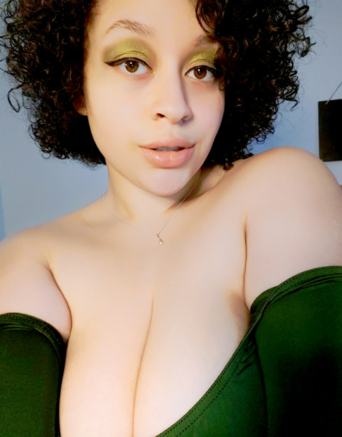 Fiestry solo female pretty girl wearing makeup with cleavage in a green dress